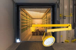 Loading dock with interior light and pallets.