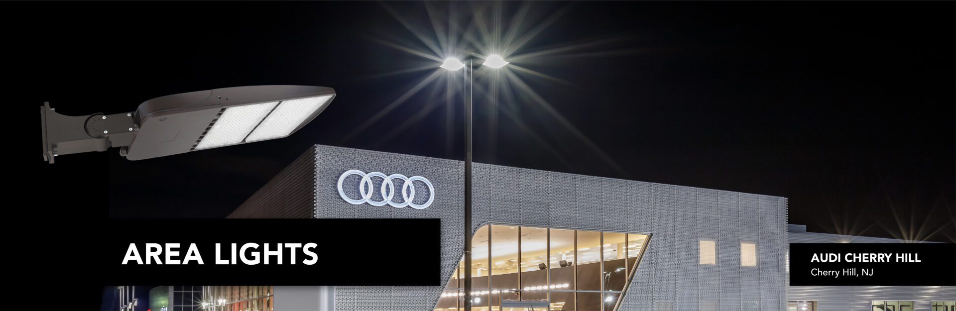 LED area lights illuminate Audi dealership.
