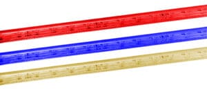 Three plastic rulers in red, blue, and yellow.