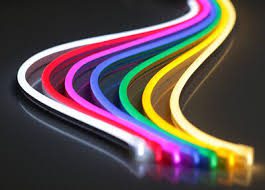 Curved neon lights in vibrant rainbow colors on a dark surface.