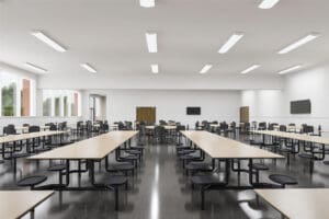 Spacious cafeteria with tables and chairs.