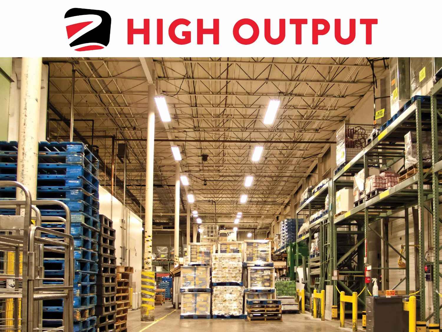 Warehouse interior with stacked pallets and shelves.